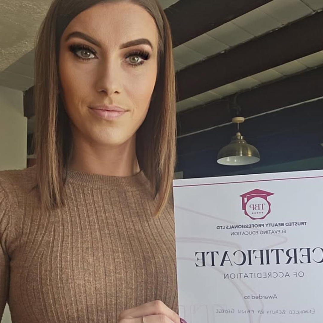 Photo of brunette woman holding TBP accreditation Certificate